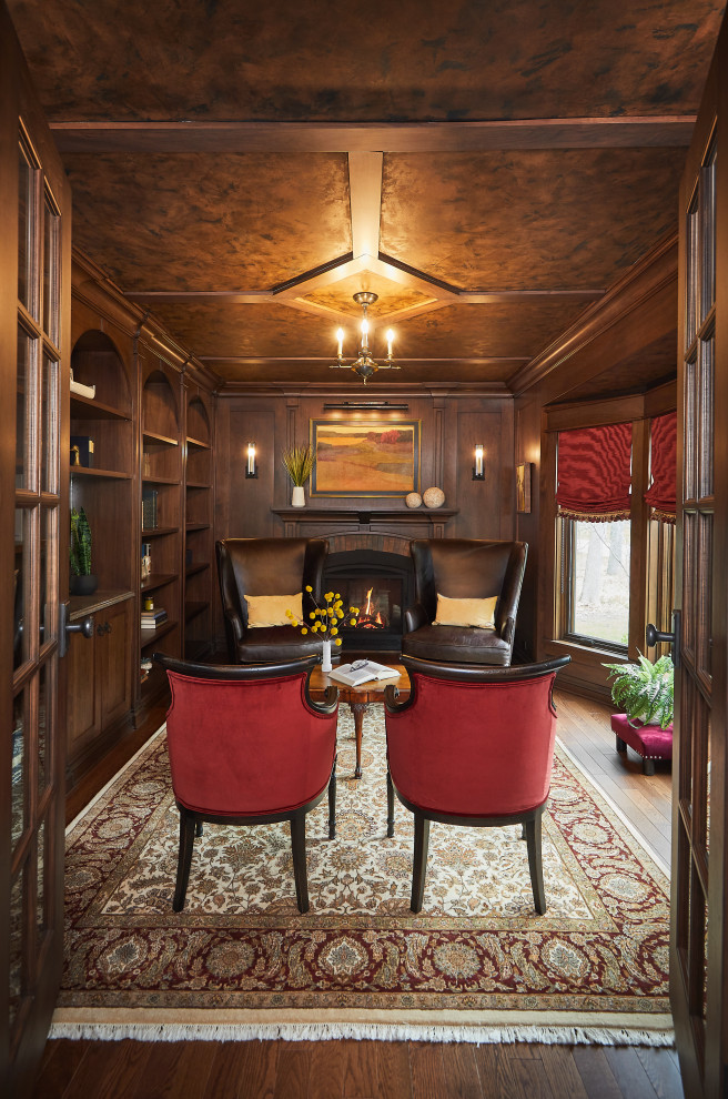 Home office library - small traditional dark wood floor, brown floor, coffered ceiling and wood wall home office library idea in Grand Rapids with brown walls, a standard fireplace and a brick fireplace