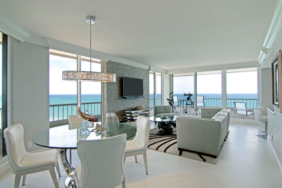 Photo of a mid-sized contemporary kitchen/dining combo in Miami with beige walls, porcelain floors and no fireplace.