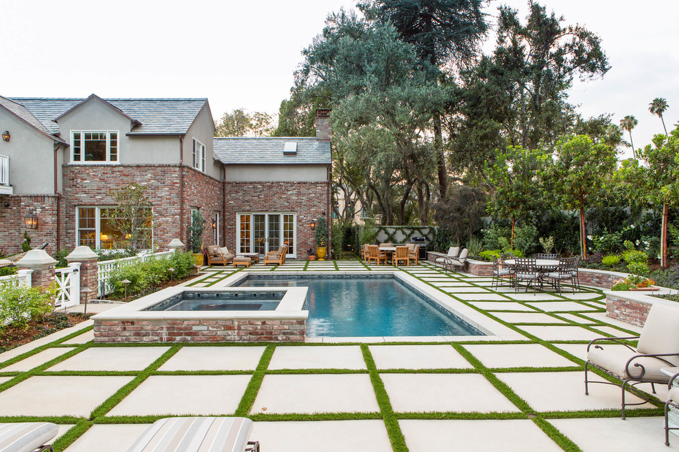 Inspiration for a traditional l-shaped pool in Los Angeles with a hot tub.