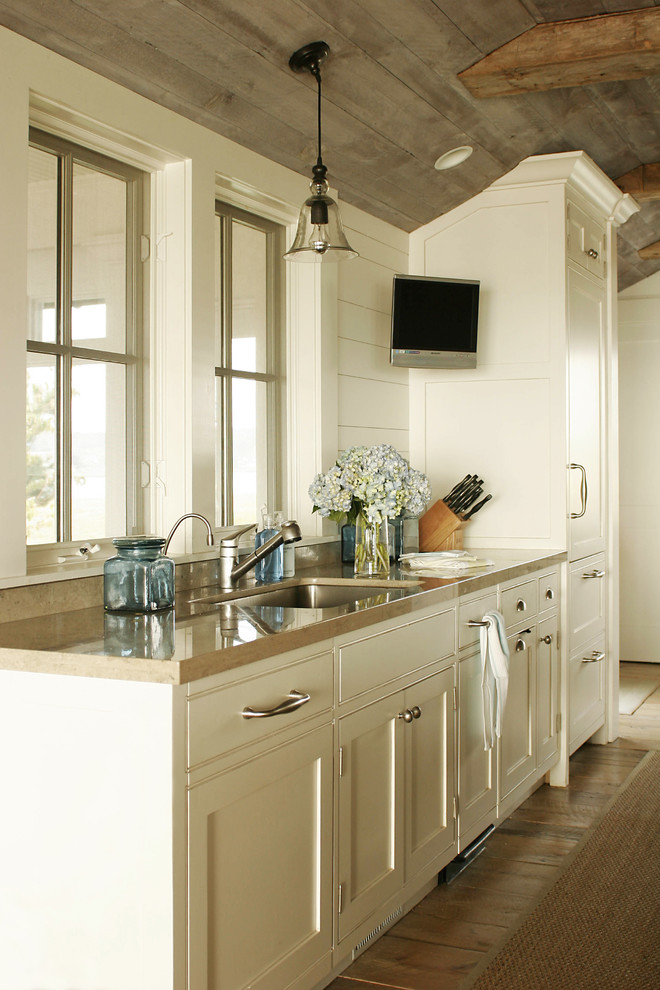 Photo of a traditional kitchen in New York with a single-bowl sink, beaded inset cabinets and white cabinets.