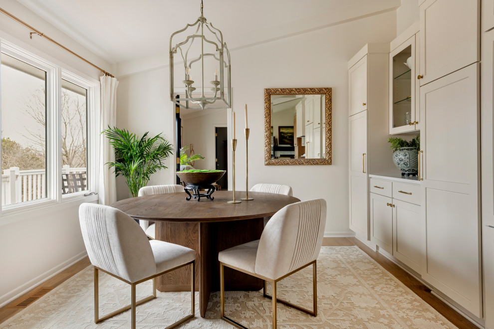 Example of a mid-sized transitional medium tone wood floor, brown floor and vaulted ceiling kitchen/dining room combo design in Minneapolis with white walls and no fireplace
