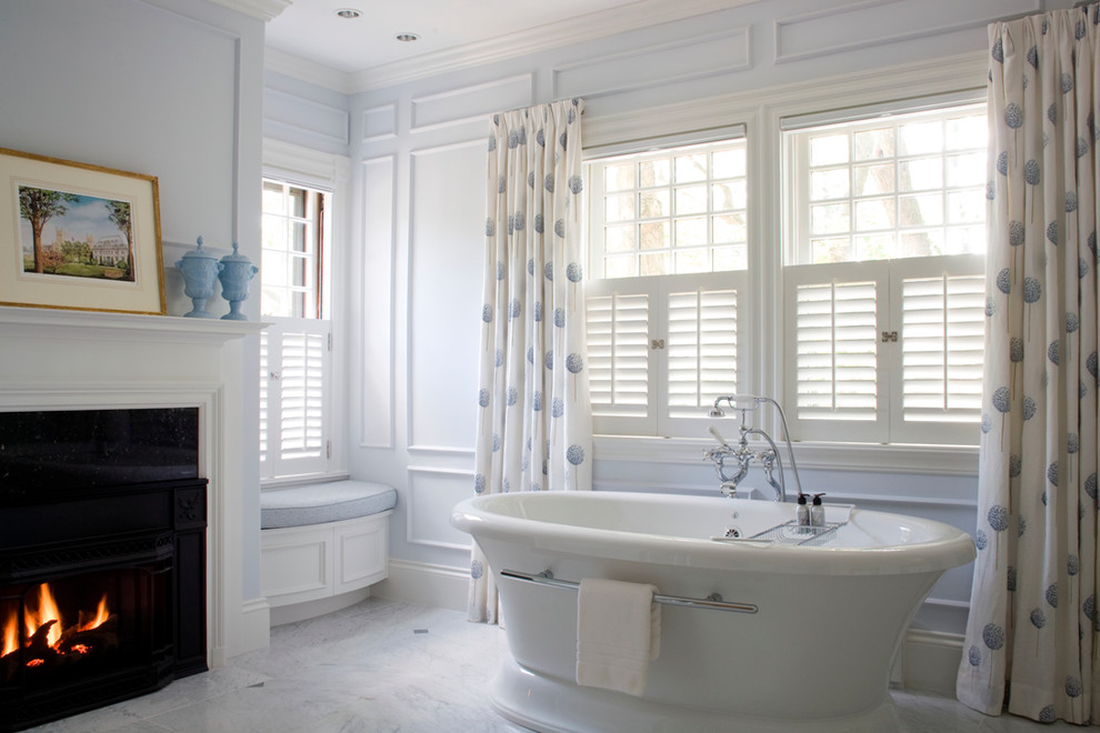 Traditional bathroom in Boston with a freestanding tub and white tile.