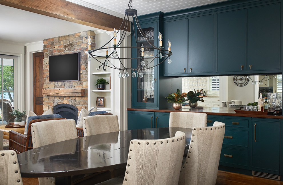 Example of a small beach style medium tone wood floor and gray floor kitchen/dining room combo design in Grand Rapids with beige walls