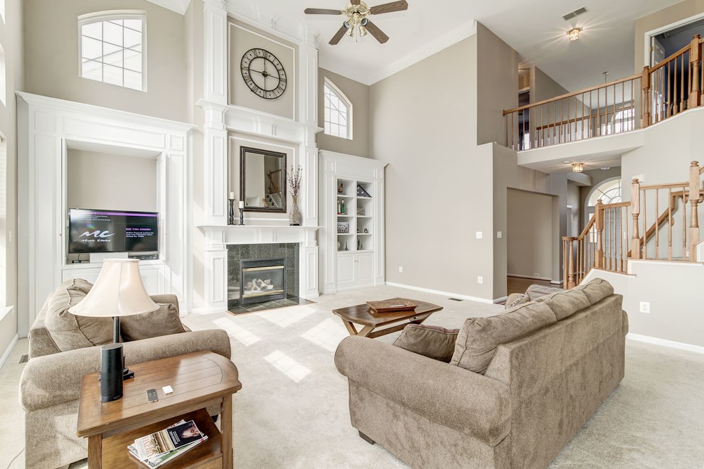 Inspiration for an expansive transitional open concept family room in DC Metro with grey walls, carpet, a standard fireplace, a stone fireplace surround, a built-in media wall and grey floor.