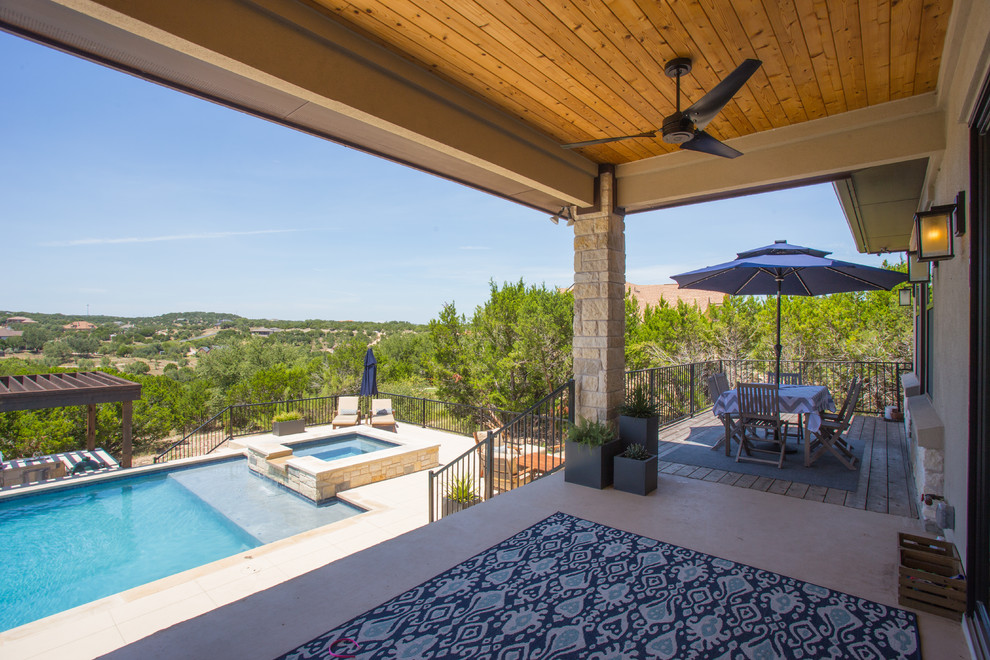 Large transitional backyard concrete and rectangular lap hot tub photo in Austin