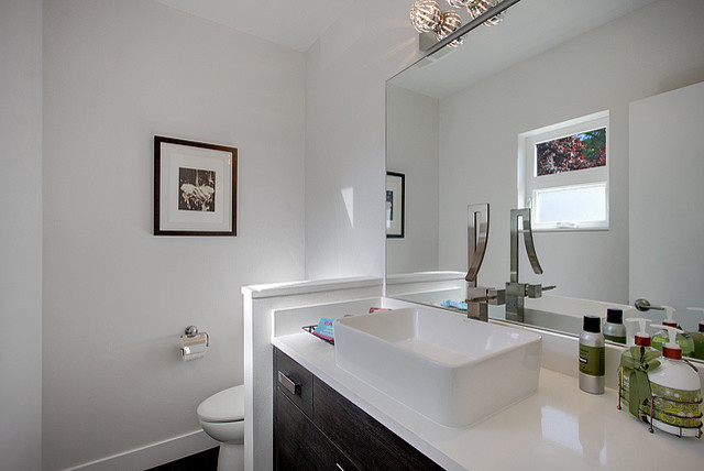 Inspiration for a contemporary bathroom remodel in Seattle with a vessel sink, flat-panel cabinets, medium tone wood cabinets, quartz countertops and white walls