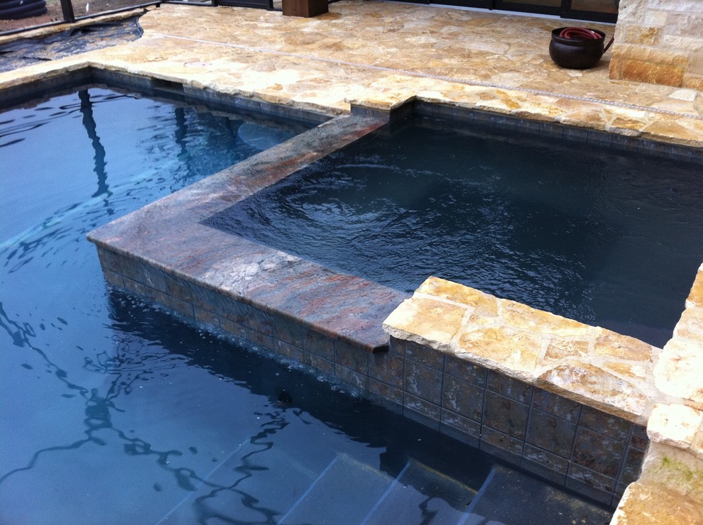 Design ideas for a mid-sized country indoor rectangular pool in Miami with a hot tub and natural stone pavers.