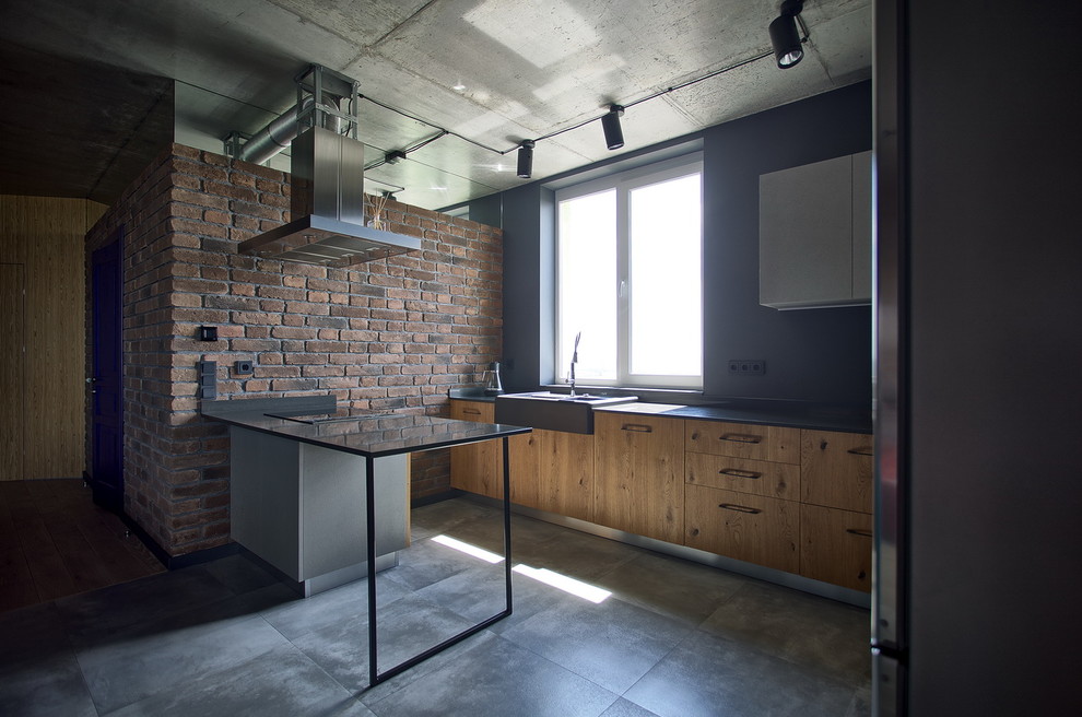 Large industrial u-shaped open plan kitchen in Other with a farmhouse sink, flat-panel cabinets, medium wood cabinets, quartzite benchtops, grey splashback, stainless steel appliances, cement tiles, a peninsula, grey floor and grey benchtop.