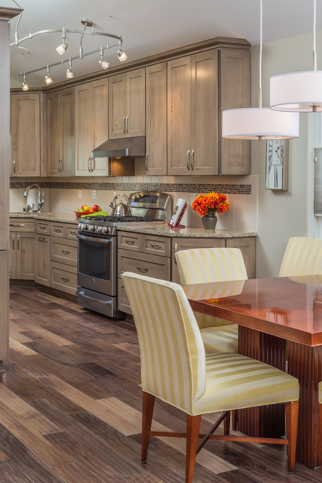 Inspiration for a mid-sized transitional galley medium tone wood floor eat-in kitchen remodel with an undermount sink, recessed-panel cabinets, gray cabinets, quartz countertops, beige backsplash, ceramic backsplash, stainless steel appliances and no island