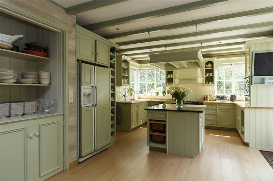 Inspiration for a mid-sized country u-shaped eat-in kitchen in Amsterdam with a drop-in sink, shaker cabinets, green cabinets, tile benchtops, white splashback, ceramic splashback, coloured appliances, light hardwood floors and with island.