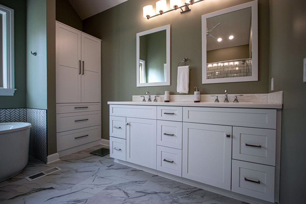 Medium sized classic ensuite bathroom in Cleveland with flat-panel cabinets, white cabinets, a freestanding bath, a corner shower, a two-piece toilet, green walls, porcelain flooring, a submerged sink, solid surface worktops, white floors, a hinged door, white worktops, a wall niche, double sinks and a freestanding vanity unit.