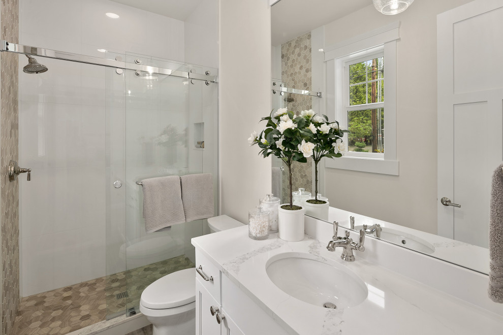 Mid-sized arts and crafts 3/4 bathroom in Seattle with shaker cabinets, white cabinets, an alcove shower, a one-piece toilet, brown tile, porcelain tile, white walls, an undermount sink, quartzite benchtops, a sliding shower screen, white benchtops, a single vanity and a built-in vanity.