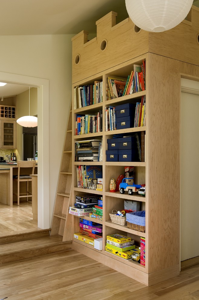 This is an example of a contemporary kids' playroom in Burlington with beige walls and light hardwood floors.