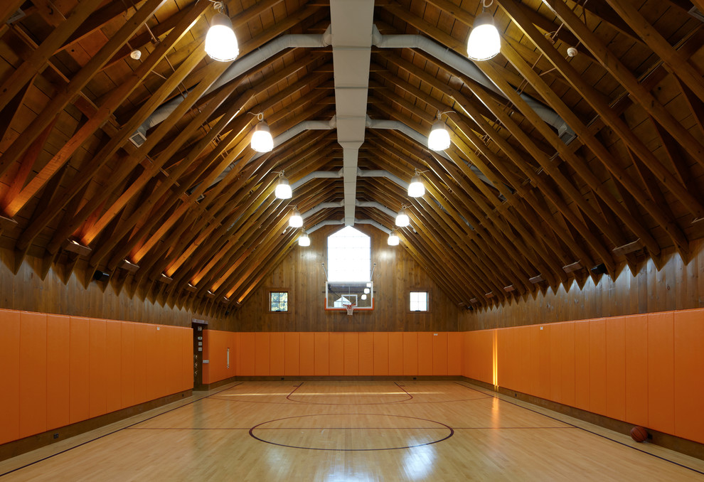 Design ideas for a country indoor sport court in Providence with orange walls and light hardwood floors.