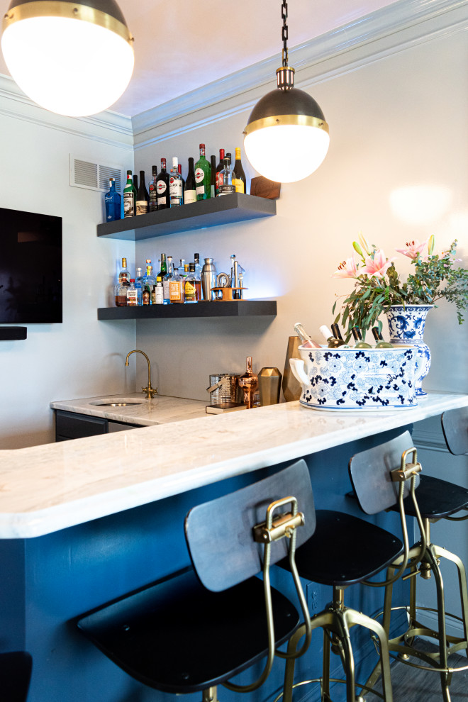This is an example of a mid-sized eclectic l-shaped wet bar in Philadelphia with an undermount sink, beaded inset cabinets, blue cabinets, quartzite benchtops, grey splashback, dark hardwood floors, brown floor and grey benchtop.