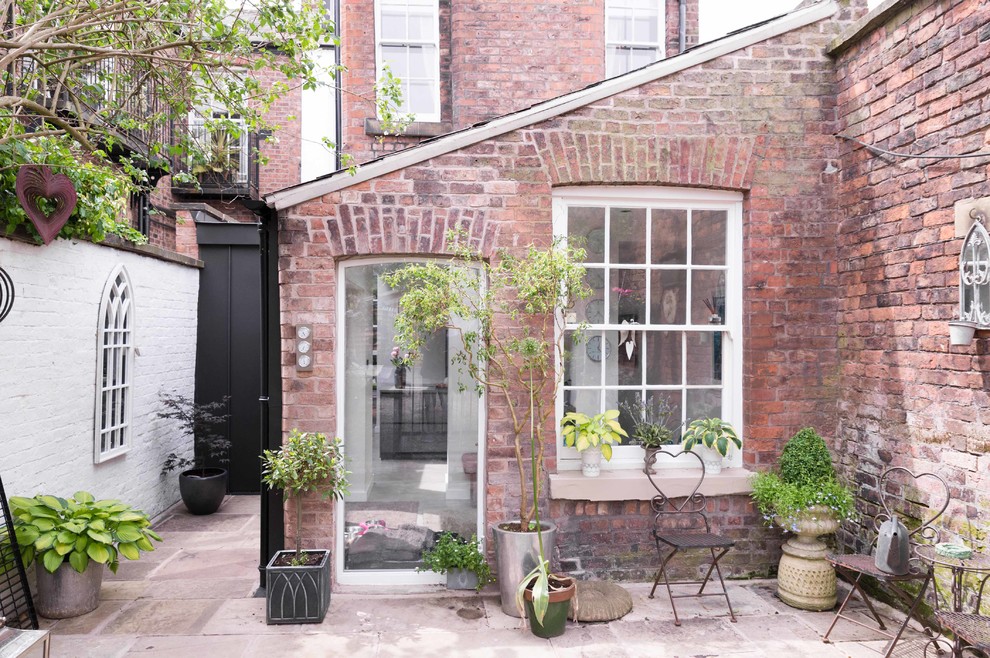 Design ideas for a contemporary red townhouse exterior in Manchester with metal siding.