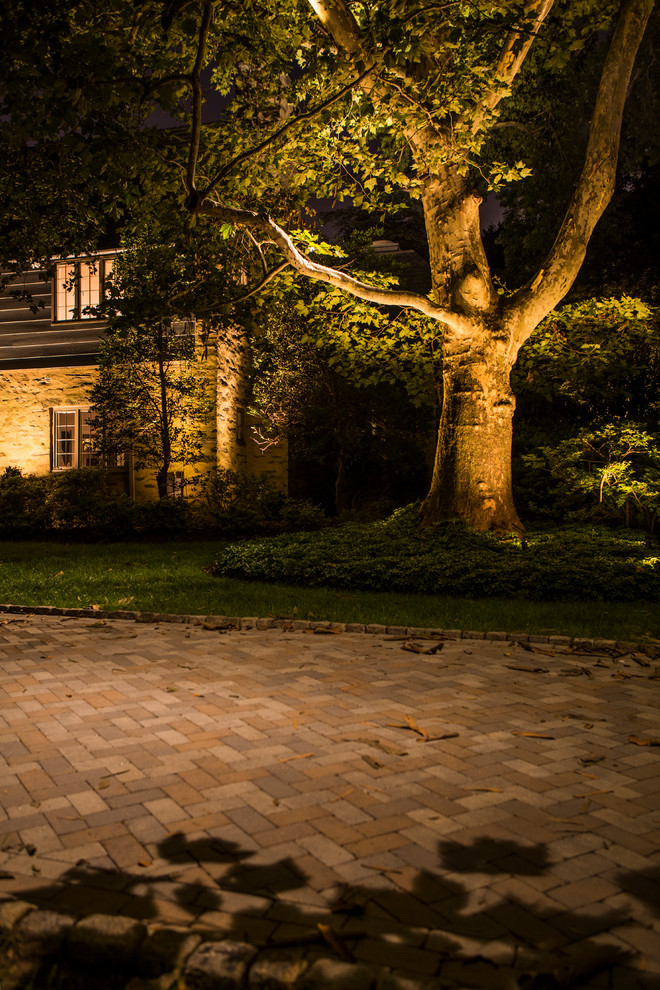 This is an example of a large traditional backyard garden in Philadelphia with brick pavers.
