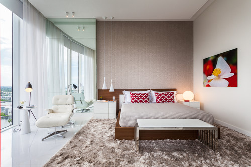 modern penthouse bedroom with large brown shaggy rug