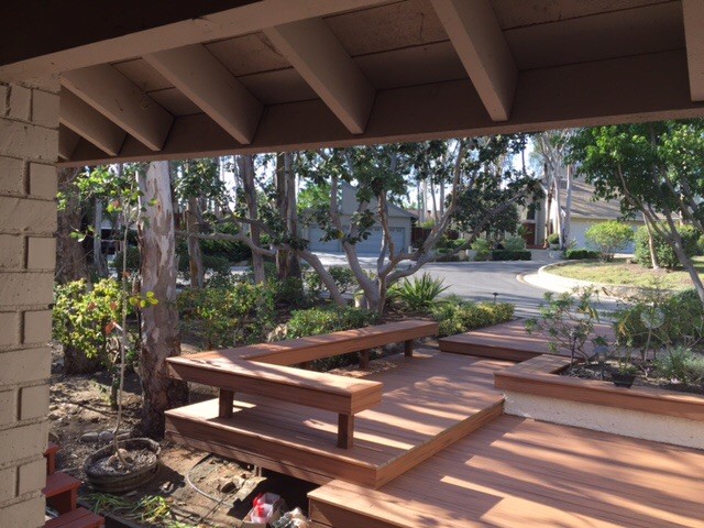 Example of a mid-sized mountain style backyard deck container garden design in Los Angeles with a roof extension