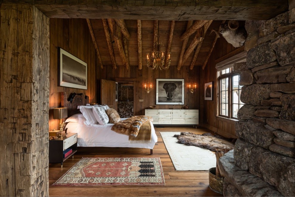 Photo of a country bedroom in Other with dark hardwood floors.