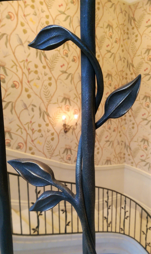 Example of a large cottage curved metal railing and wallpaper staircase design in Hampshire