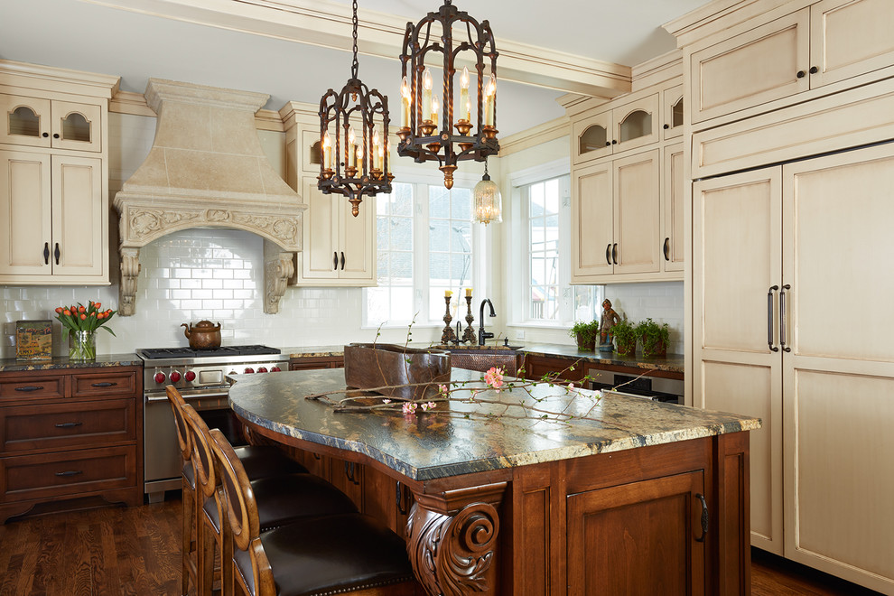 Traditional l-shaped kitchen in Minneapolis with recessed-panel cabinets, beige cabinets, white splashback, medium hardwood floors, with island and panelled appliances.