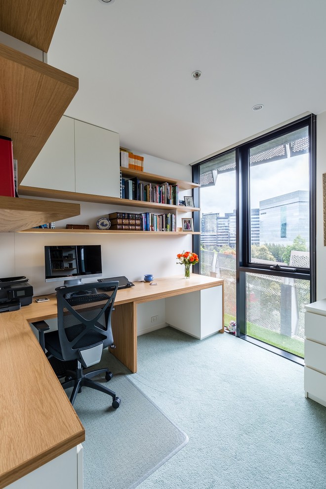 Mid-sized contemporary study room in Melbourne with white walls, carpet and a built-in desk.