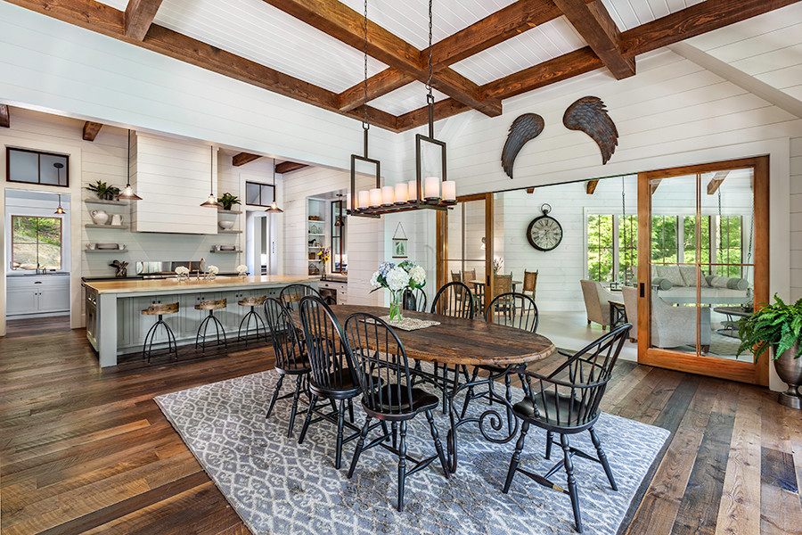 Photo of a large country kitchen/dining combo in Other with white walls, dark hardwood floors and no fireplace.