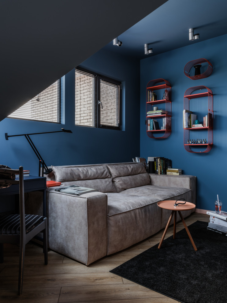 Идея дизайна: рабочее место среднего размера в стиле фьюжн с синими стенами, светлым паркетным полом, отдельно стоящим рабочим столом, коричневым полом, сводчатым потолком и кирпичными стенами
