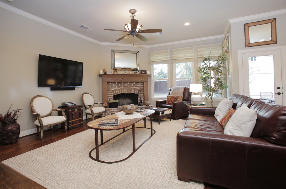 Country living room in Dallas with a brick fireplace surround and a corner fireplace.