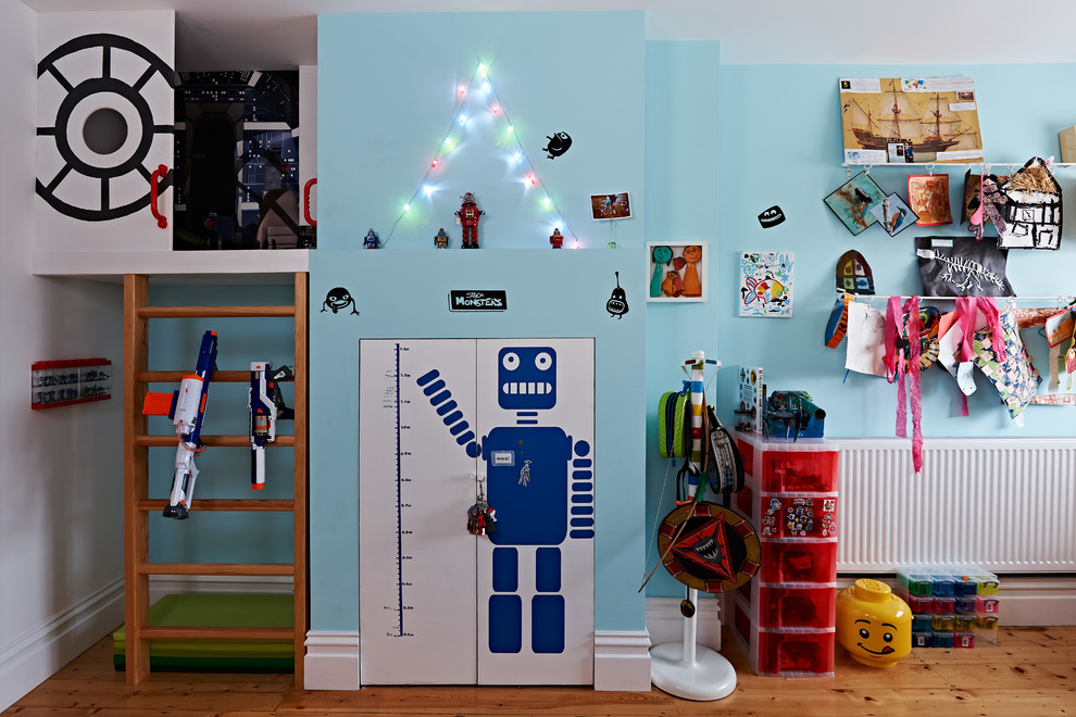 Design ideas for a mid-sized contemporary kids' playroom for kids 4-10 years old and boys in Other with multi-coloured walls.