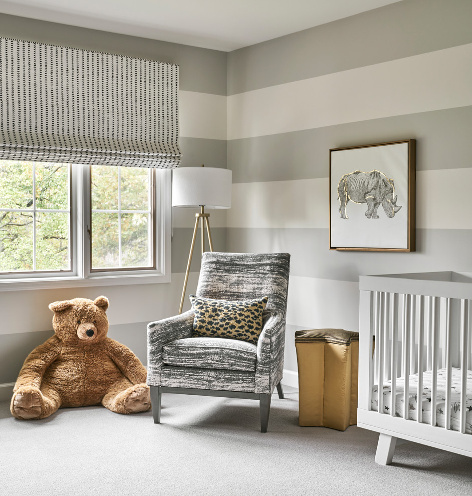 Photo of a transitional gender-neutral nursery in Chicago with carpet, grey floor and orange walls.