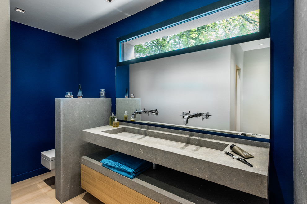 Réalisation de salle d'eau in bois clair With une douche à l'italienne, un sol en calcaire, un plan de toilette en calcaire, un sol gris, un plan de toilette gris, un placard à porte affleurante, WC suspendus, du carrelage en pierre calcaire, un mur gris, un lavabo encastré and aucune cabine.