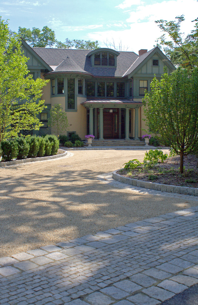 Photo of a large traditional courtyard partial sun driveway in Boston with gravel.