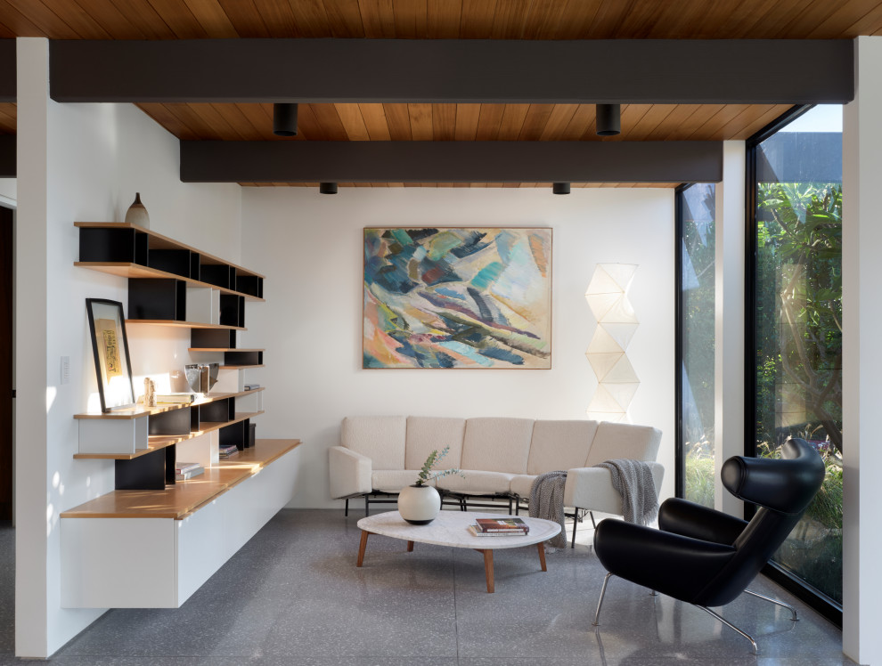 Living room - 1950s gray floor, exposed beam and wood ceiling living room idea in Los Angeles with white walls