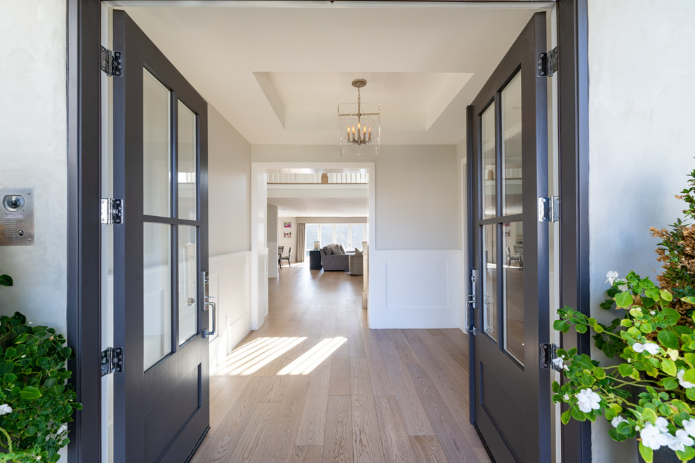 Foyer - huge transitional light wood floor foyer idea in Los Angeles