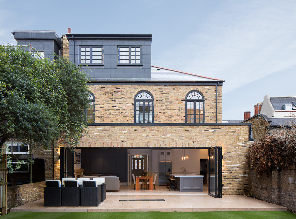 Photo of a large contemporary three-storey brick exterior in London.