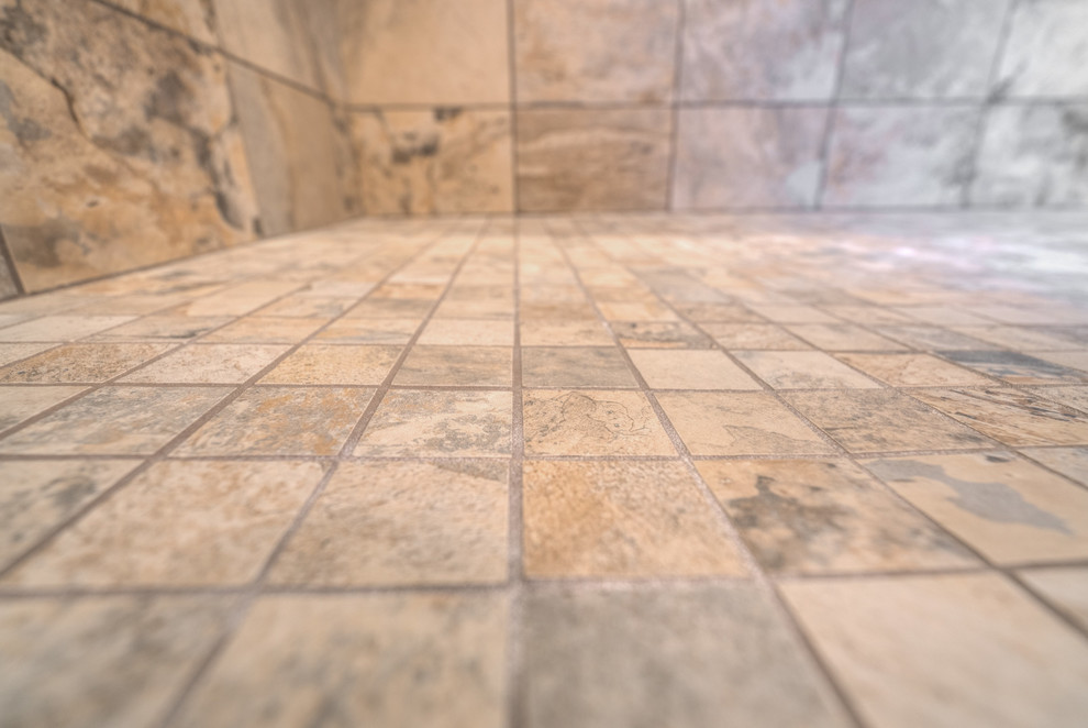 Mid-sized transitional master multicolored tile ceramic tile home design photo with raised-panel cabinets, beige cabinets, a two-piece toilet, beige walls, an undermount sink and quartz countertops