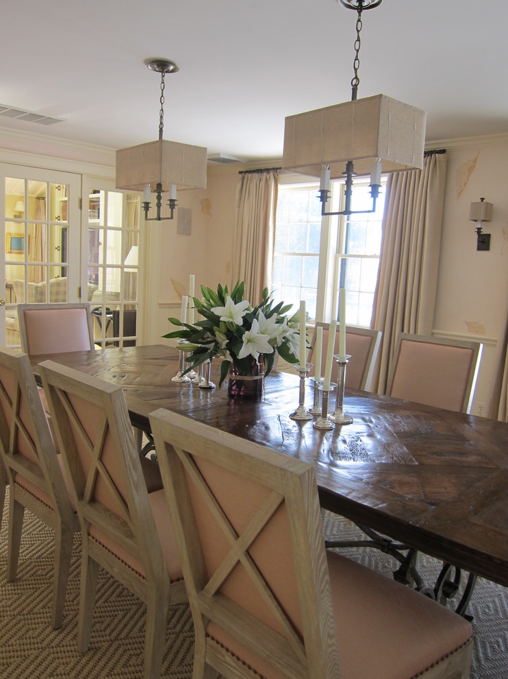 This is an example of a transitional separate dining room in Boston with pink walls.
