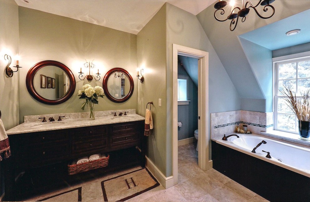 Photo of a mid-sized traditional master bathroom in Philadelphia with an undermount sink, recessed-panel cabinets, brown cabinets, marble benchtops, a drop-in tub, a corner shower, a one-piece toilet, multi-coloured tile, ceramic tile, green walls, ceramic floors and a hinged shower door.