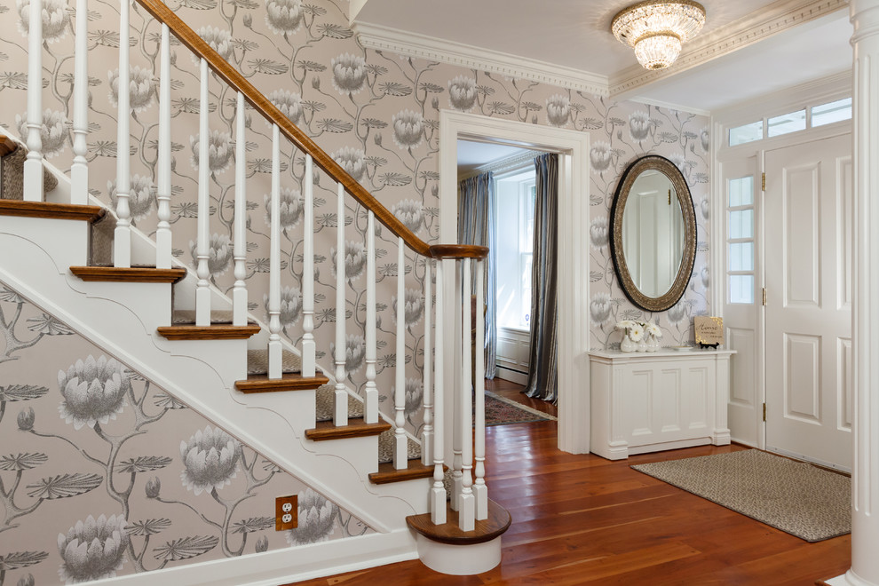 This is an example of a large traditional foyer in Toronto with multi-coloured walls, medium hardwood floors, a single front door, a white front door and brown floor.