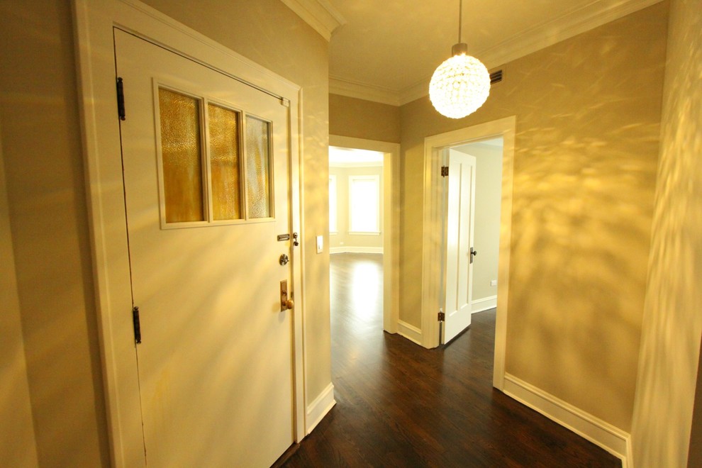 Front door - small transitional dark wood floor and brown floor front door idea in Chicago with beige walls and a white front door