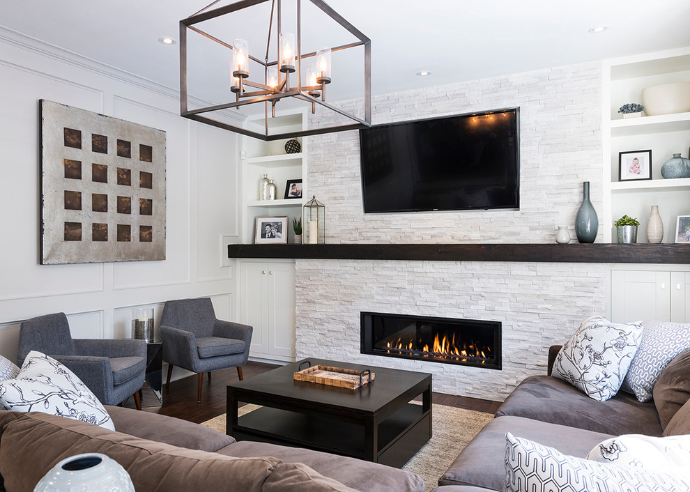 This is an example of a mid-sized transitional open concept living room in Toronto with white walls, dark hardwood floors, a stone fireplace surround, a wall-mounted tv and a ribbon fireplace.