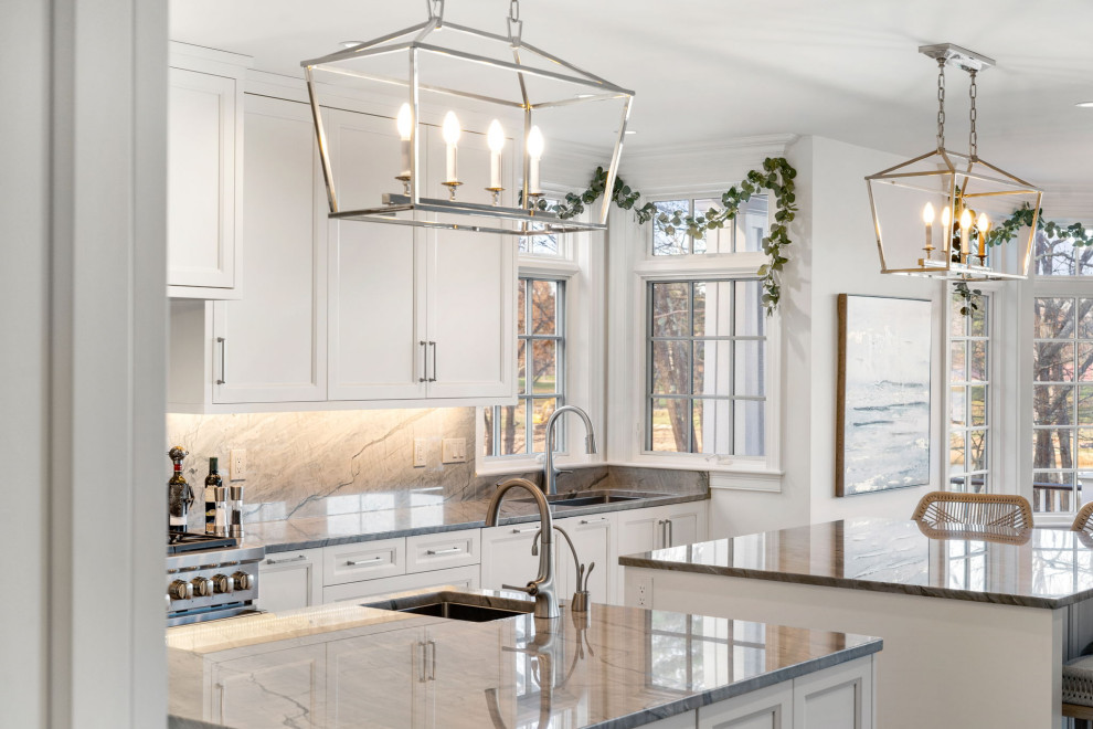Huge transitional eat-in kitchen photo in Boston with an undermount sink, shaker cabinets, white cabinets, quartzite countertops, paneled appliances and two islands