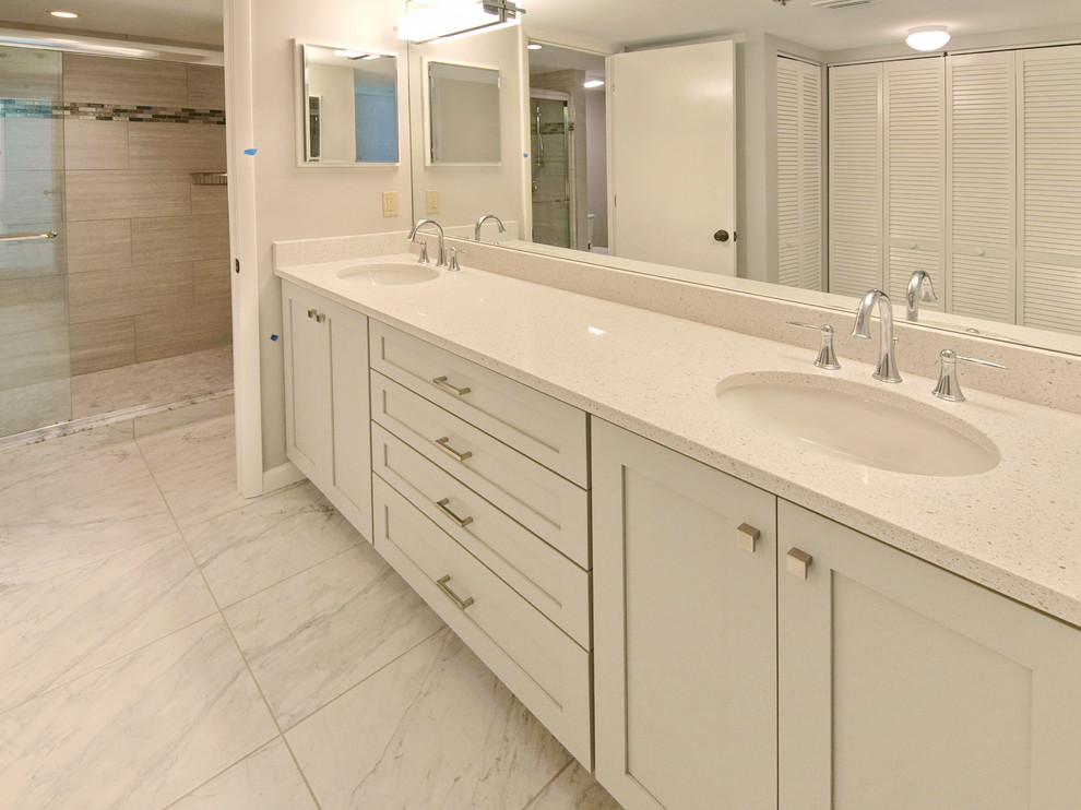 Inspiration for a large contemporary master bathroom in Tampa with shaker cabinets, white cabinets, an alcove shower, white tile, stone tile, white walls, marble floors, an undermount sink and engineered quartz benchtops.