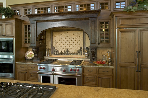 This dream kitchen features multiple stove tops.