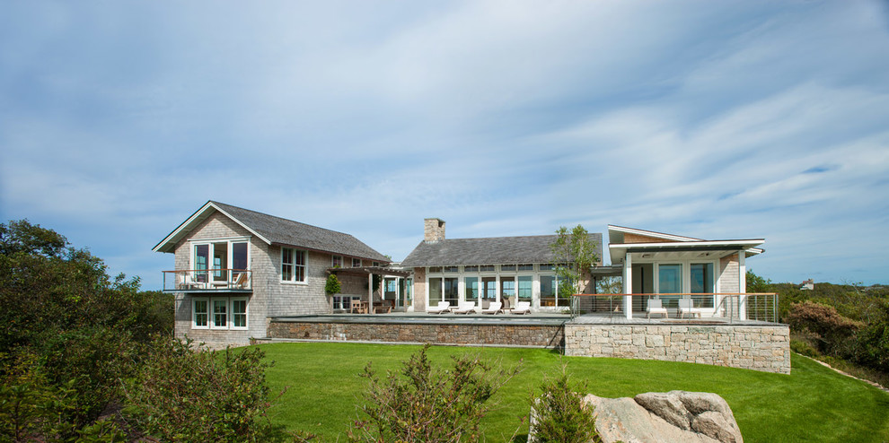 Inspiration for a beach style two-storey exterior in Providence with wood siding and a gable roof.