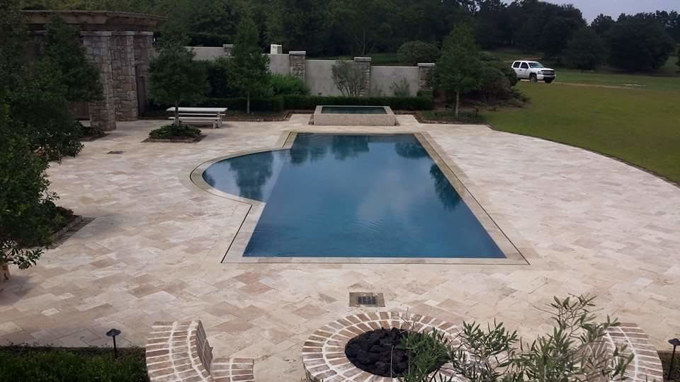 Photo of a mid-sized contemporary backyard rectangular natural pool in Miami with a hot tub and concrete pavers.