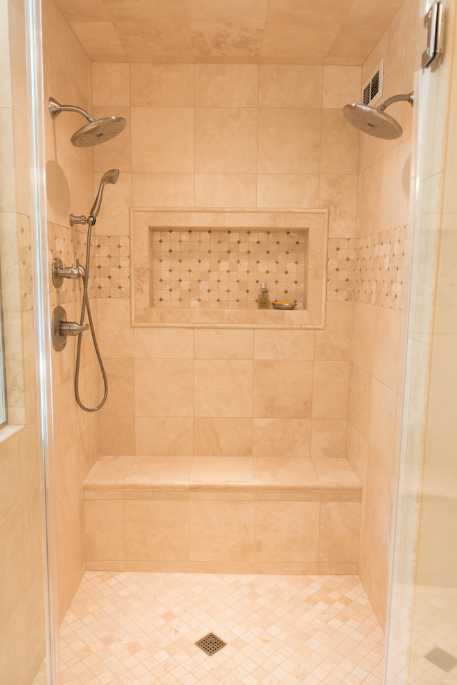 Photo of a large classic ensuite bathroom in Milwaukee with white cabinets, a built-in bath, a built-in shower, beige tiles, travertine tiles, beige walls, travertine flooring, beige floors and a hinged door.