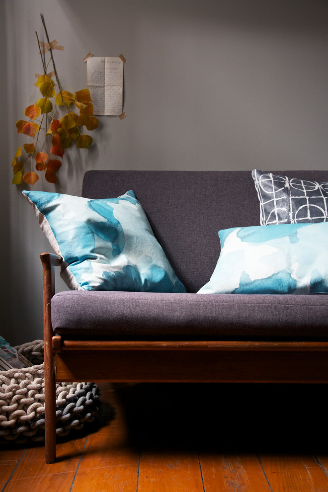 Mid-sized contemporary guest bedroom in Sydney with white walls, medium hardwood floors and brown floor.